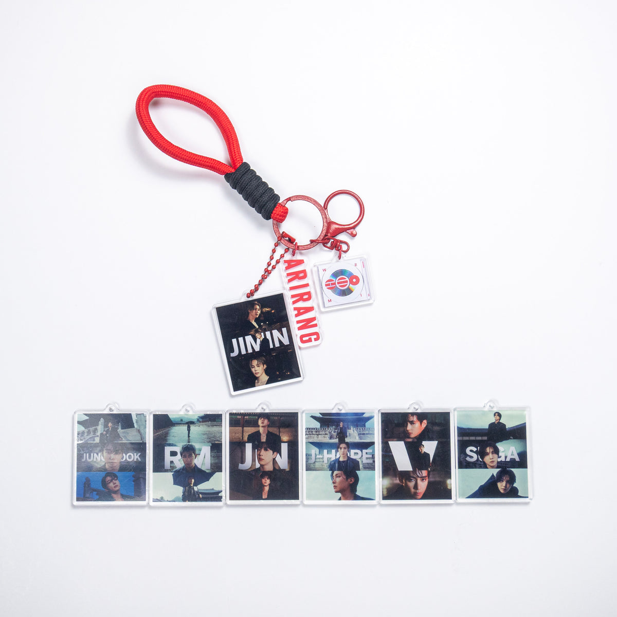 BTS ARIRANG red rope wristlet keychain with red hardware, Jimin acrylic photo charm, and six other BTS member photo charm options on a white background.