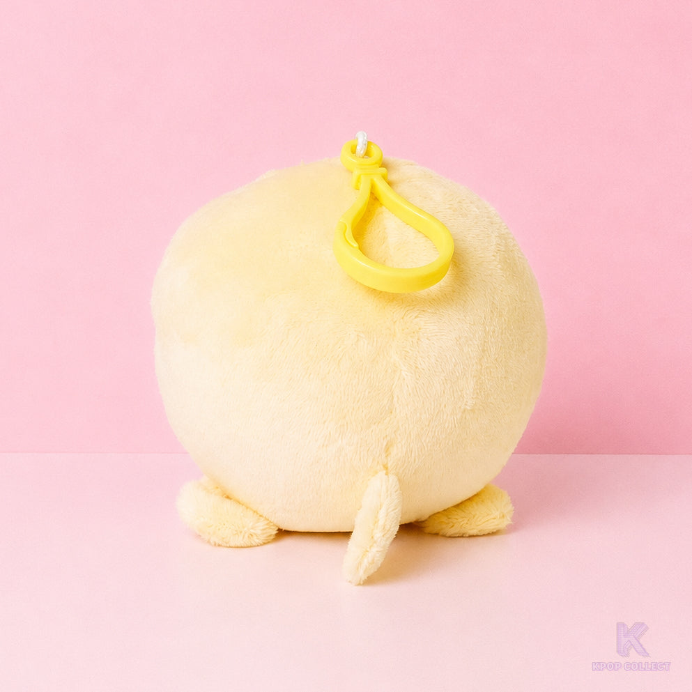 A back view of the soft, yellow Stray Kids Felix BbokAri plush keychain, showcasing its round shape and fluffy texture against a clean background.