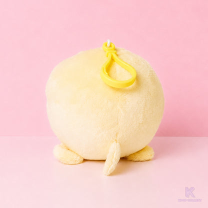 A back view of the soft, yellow Stray Kids Felix BbokAri plush keychain, showcasing its round shape and fluffy texture against a clean background.