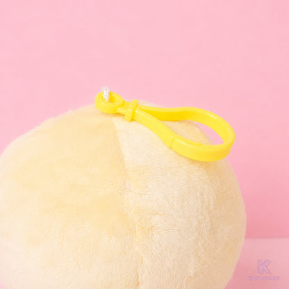 A close-up detail of the yellow attachment clip on the top of the fluffy Stray Kids Felix BbokAri plush keychain