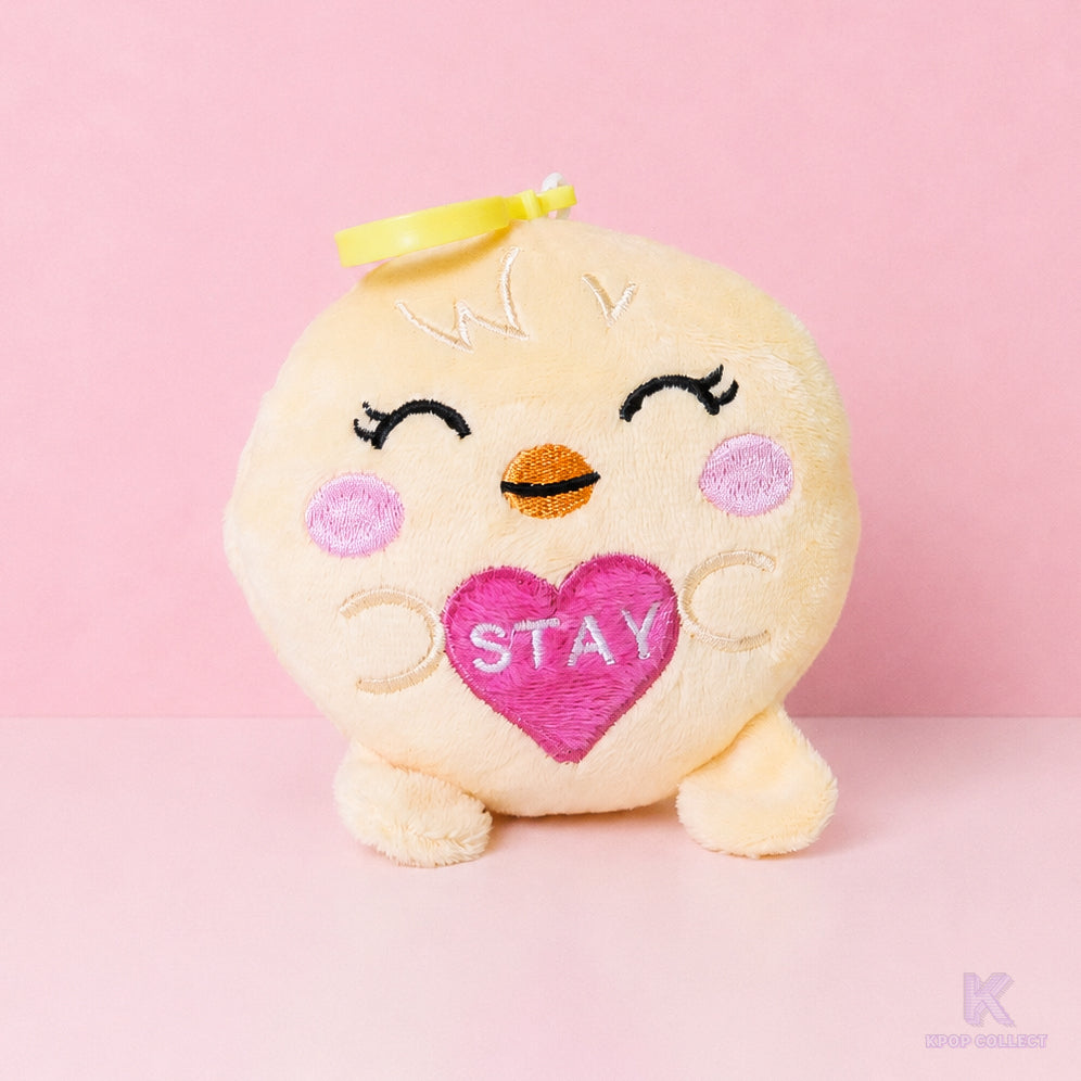 A direct, front-facing view of the Stray Kids Felix BbokAri plush keychain. The adorable yellow chick character is holding a small pink heart with the word 'STAY' embroidered on it.